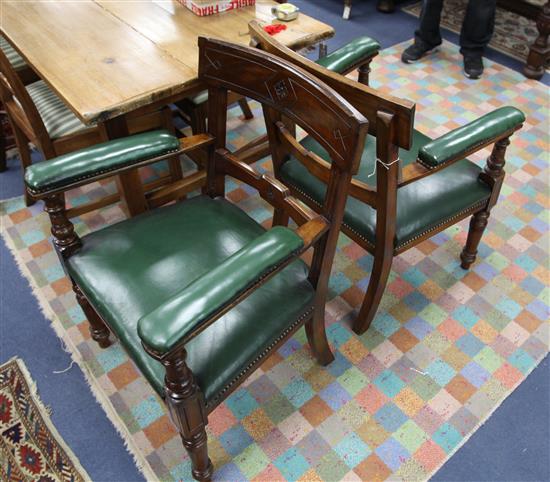 A pair of Victorian mahogany armchairs, with green leather seats